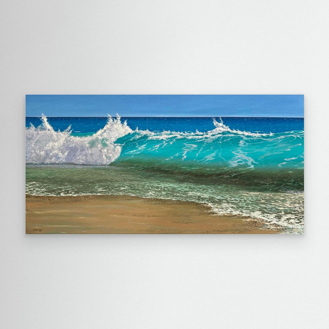 Ocean wave breaking on a sandy beach, printed on canvas and displayed on a neutral wall
